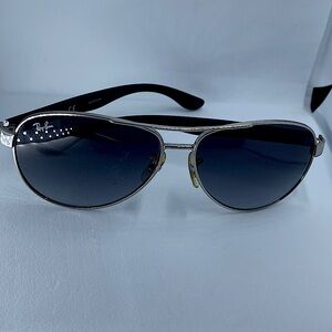 Ray-Ban Aviator Sunglasses. Light black lenses. Black bows with silver frames.